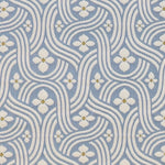 Detail of fabric in a floral damask print in white and gold on a light blue field.