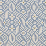 Detail of fabric in a floral damask print in white and gold on a light blue field.