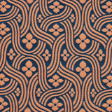 Detail of fabric in a floral damask print in orange on a dark blue field.