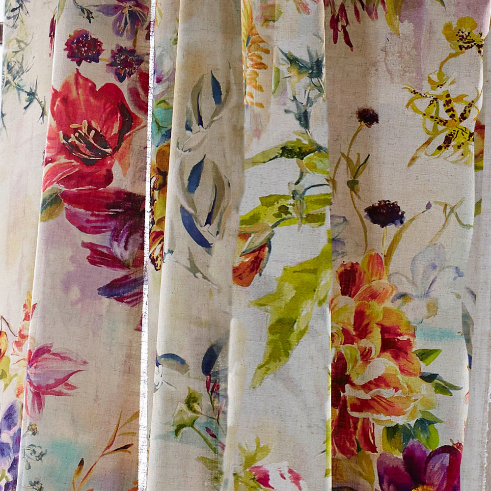 Draped fabric in a painterly floral print in a variety of colors on a mottled cream field.