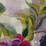 Close-up of fabric in a painterly floral print on a mottled cream field.