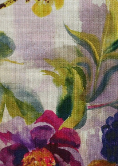 Close-up of fabric in a painterly floral print on a mottled cream field.