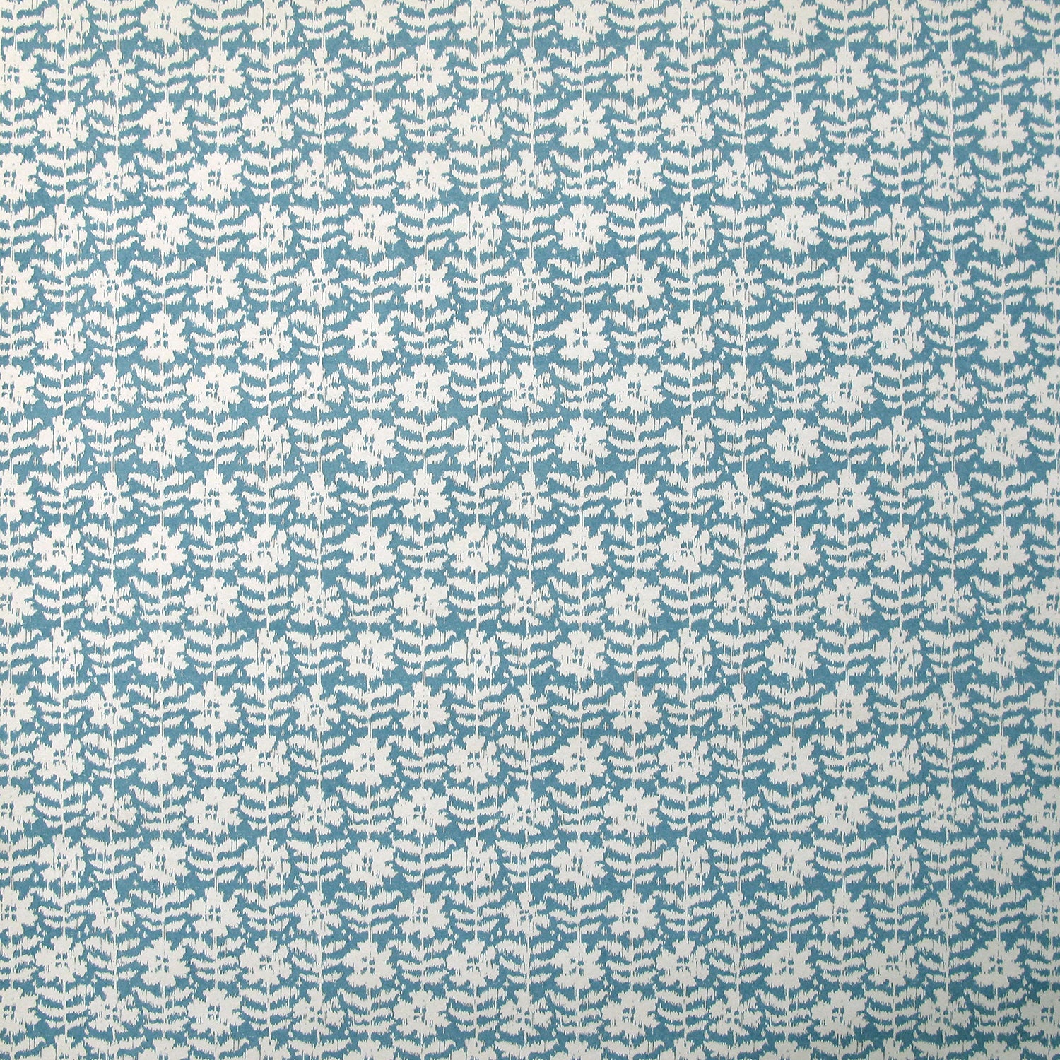 Detail of wallpaper in a floral grid print in white on a blue field.