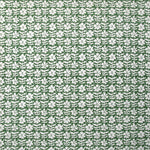 Detail of wallpaper in a floral grid print in white on a forest green field.