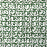 Detail of wallpaper in a floral grid print in white on a forest green field.