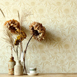 Wallpaper in a warm tan botanical design of clover flowers and leaves, with a wooden shelf with vases of dried flowers