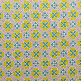 Detail of fabric in a floral lattice print in pink, yellow, teal and white.