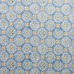 Detail of fabric in a floral lattice print in blue, green and white.