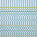 Detail of fabric in a dense irregular check print in light blue with yellow and green accents on a white field.