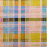 Detail of fabric in a rainbow plaid print.