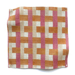 Square fabric swatch in an interlocking checked pattern in shades of tan, pink and orange.