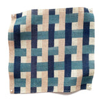 Square fabric swatch in an interlocking checked pattern in shades of pink, blue and navy.