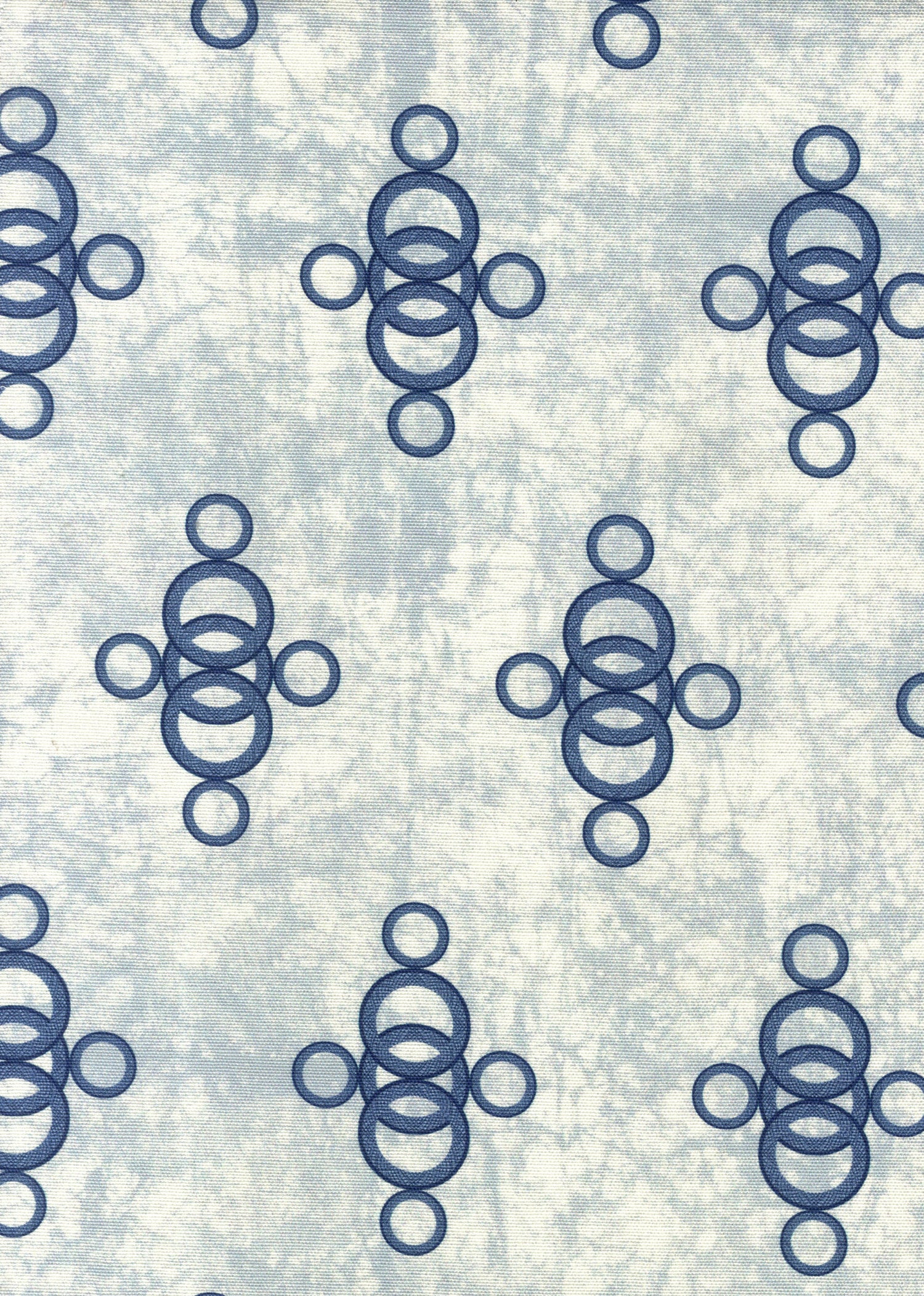 Detail of fabric in a curving lattice print in navy on a mottled blue field.