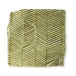 Square fabric swatch in a dense herringbone print in olive on a tan field.