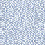 Detail of fabric in a dense herringbone print in blue on a white field.