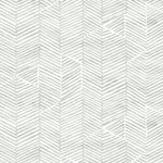 Detail of fabric in a dense herringbone print in light green on a white field.