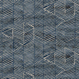 Detail of fabric in a dense herringbone print in navy on a tan field.