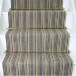 Striped flatweave runner in multi red yellow and blue on white stairs 