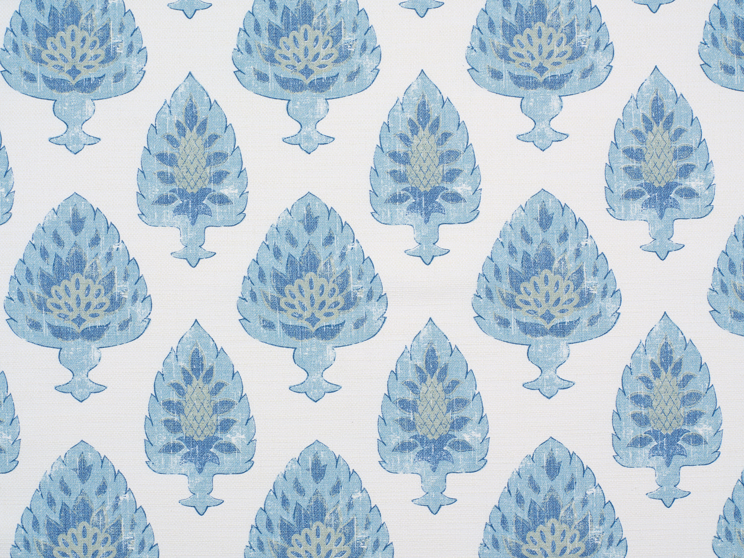 Detail of fabric in a botanical damask print in shades of green and blue on a cream field.