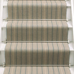 Striped flatweave runner in tan and blue on white staircase