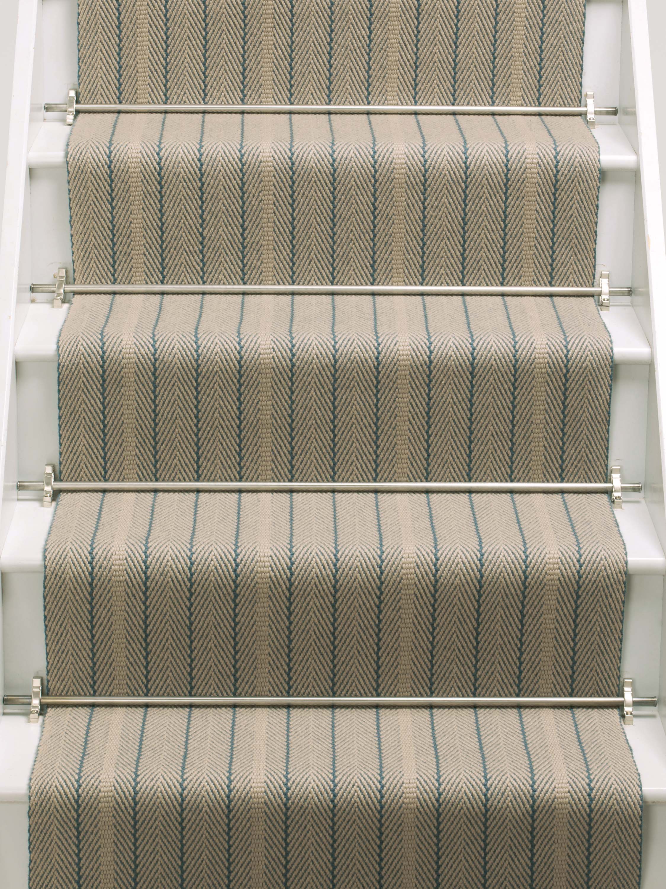 Striped flatweave runner in tan and blue on white staircase