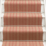 Striped flatweave runner in raspberry and red on white staircase