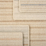 A stack of broadloom carpets in a dashed stripe pattern in a range of colors.