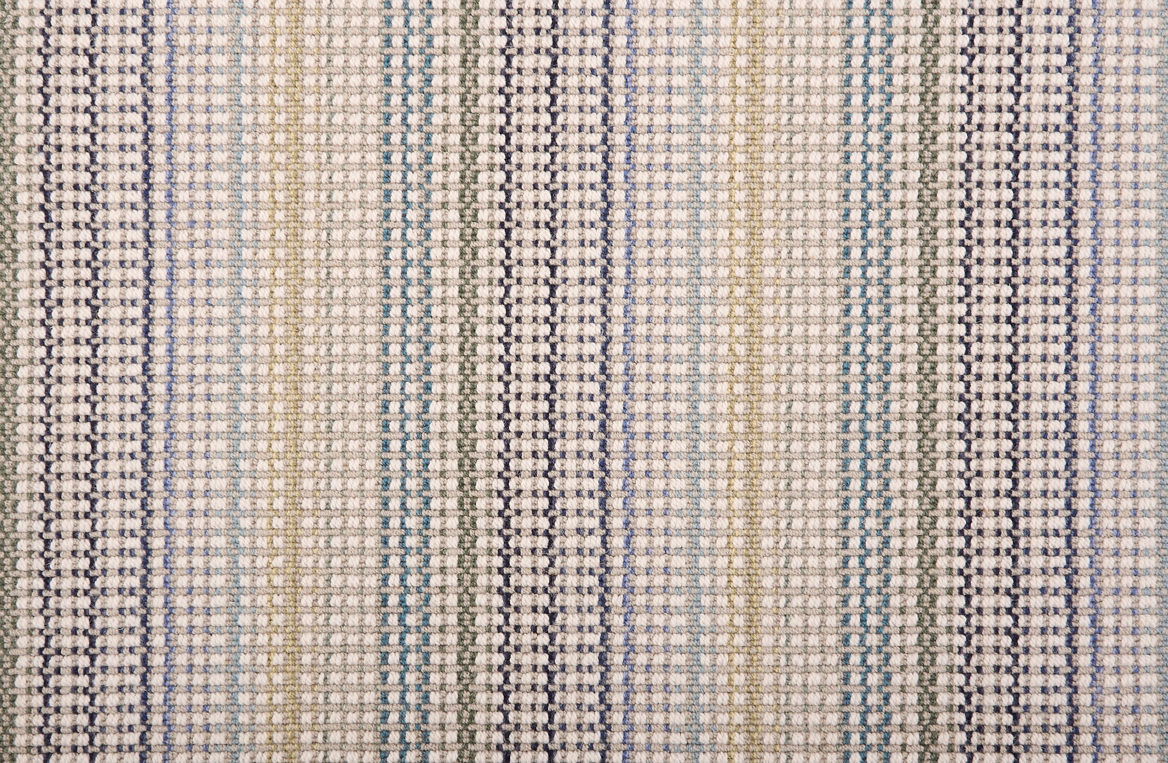 Broadloom carpet in a textural multi color stripe in beige, blue, tan and teal.