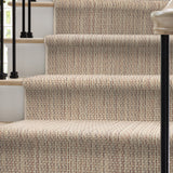 Staircase with textured beige carpeting in a home setting