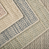 Close-up of various textured rugs with textural stripe patterns in five colors. 