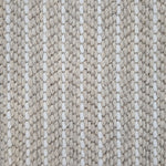 Close-up of a broadloom carpet with vertical stripes in beige and white.