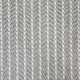 Close-up of a broadloom carpet with vertical stripes in grey and white.