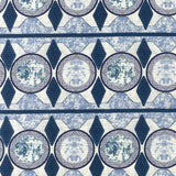 Detail of fabric in an intricate geometric stripe in shades of blue, navy and cream.