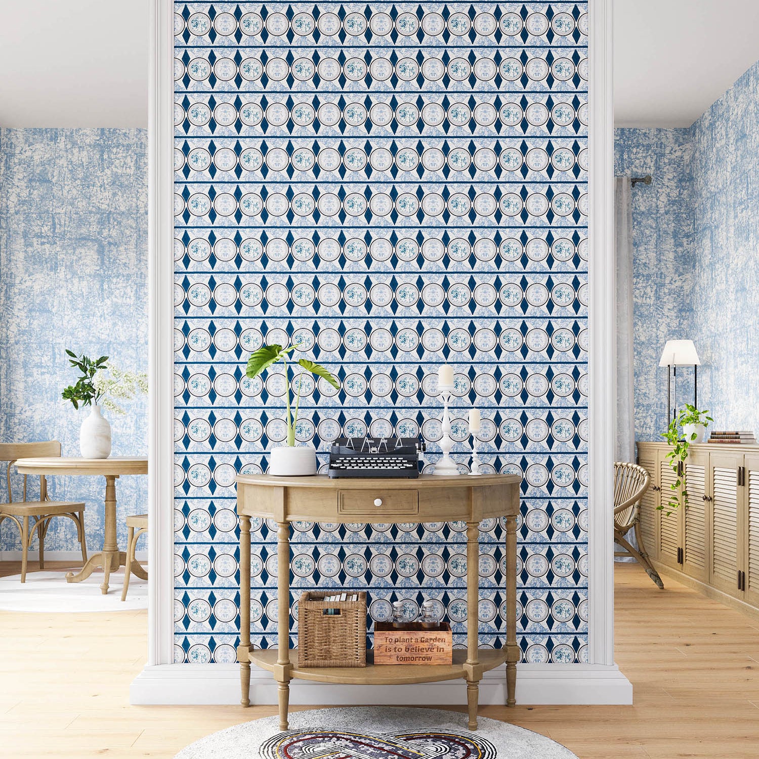 A maximalist living space with an accent wall papered in an intricate geometric stripe in shades of blue, navy and cream.