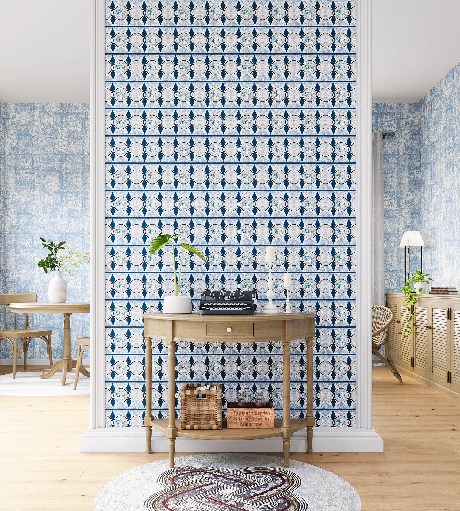 A maximalist living space with an accent wall papered in an intricate geometric stripe in shades of blue, navy and cream.