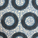 Patterned fabric with circular designs on a blue background