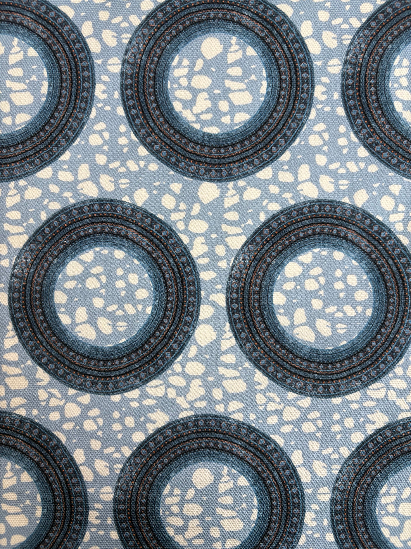 Patterned fabric with circular designs on a blue background
