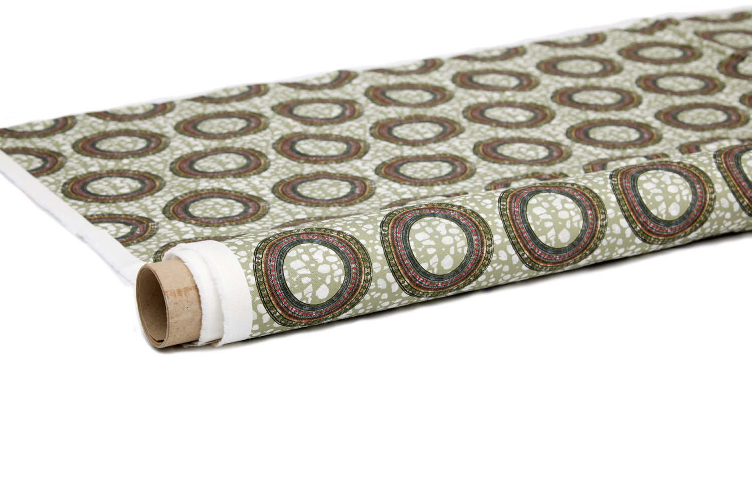 Partially unrolled fabric in an intricate circular print in shades of green, orange and cream.