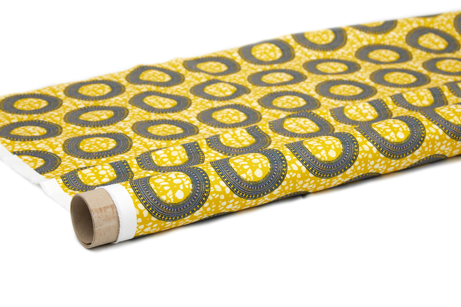 Partially unrolled fabric in an intricate circular print in shades of yellow, blue and white.