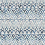 Detail of fabric in a painterly ikat print in shades of blue and navy on a white field.