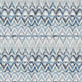 Detail of fabric in a painterly ikat print in shades of blue and navy on a white field.