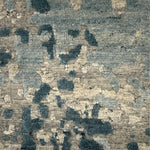 Handknotted rug in an abstract texture in shades of blue and grey. 