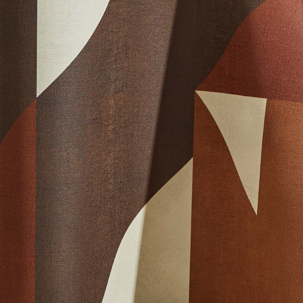 Draped wallpaper yardage in a large-scale geometric print in brown and rust on a cream field.