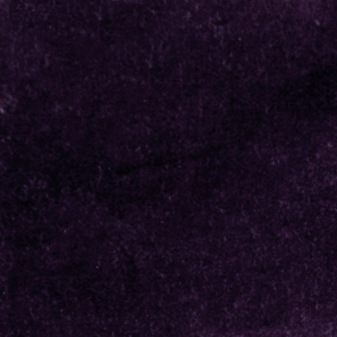 Detail of velvet fabric yardage in dark purple.