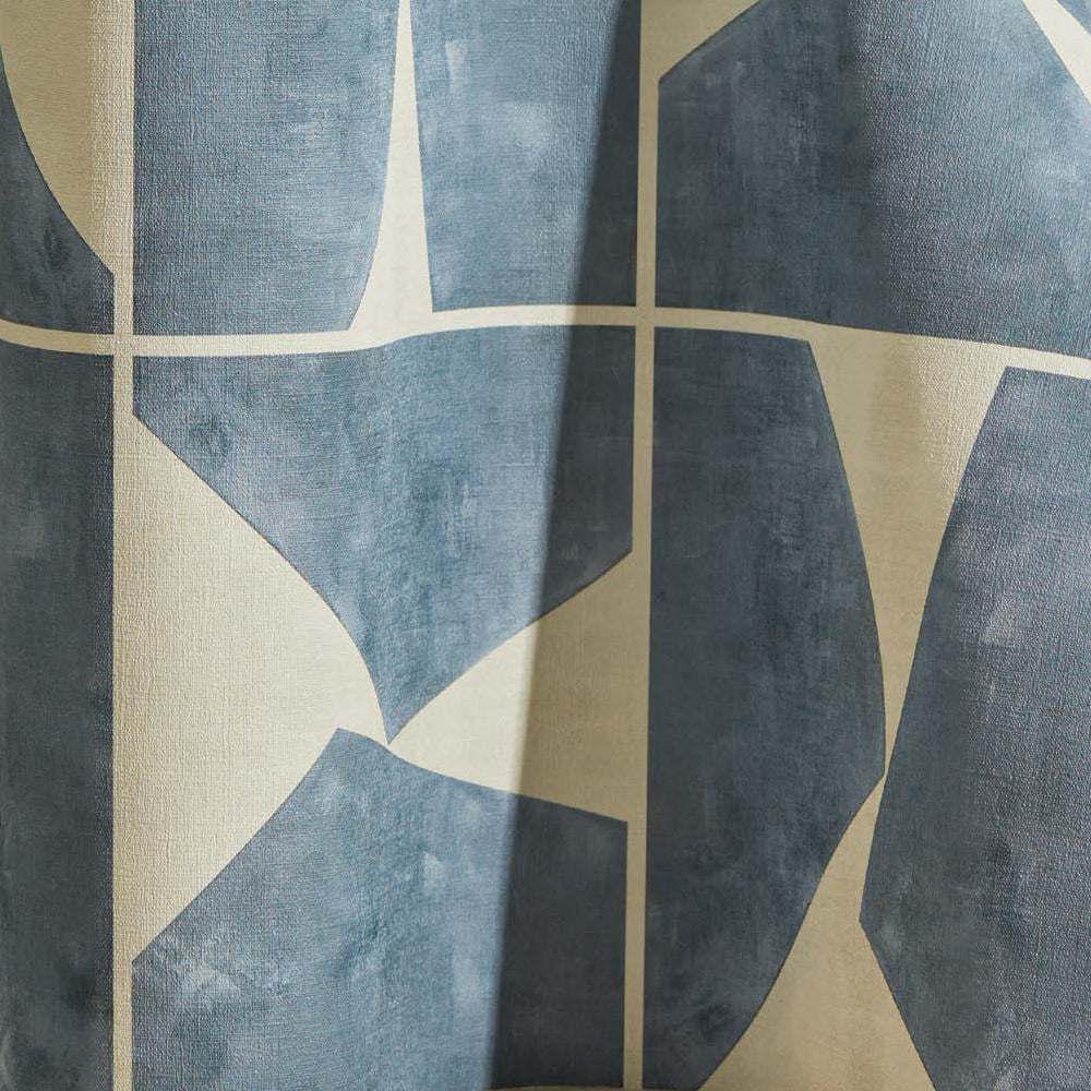 Draped wallpaper yardage in a geometric grid print in blue-gray on a mottled cream field.