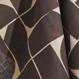 Draped fabric yardage in a large-scale curvilinear geometric print in brown on a cream field.