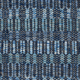 Handwoven rug detail in a geometric  design in blue and black 