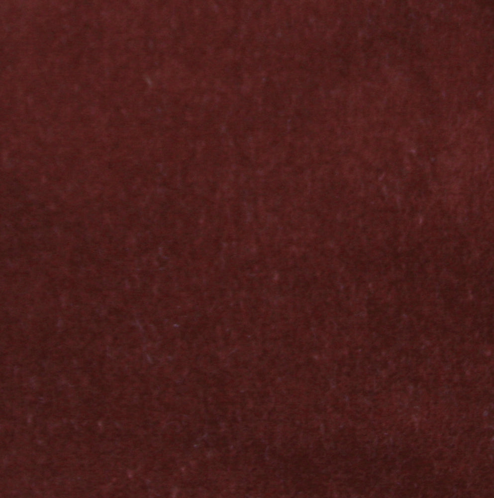 Detail of velvet fabric yardage in maroon.