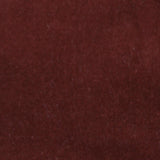 Detail of velvet fabric yardage in maroon.