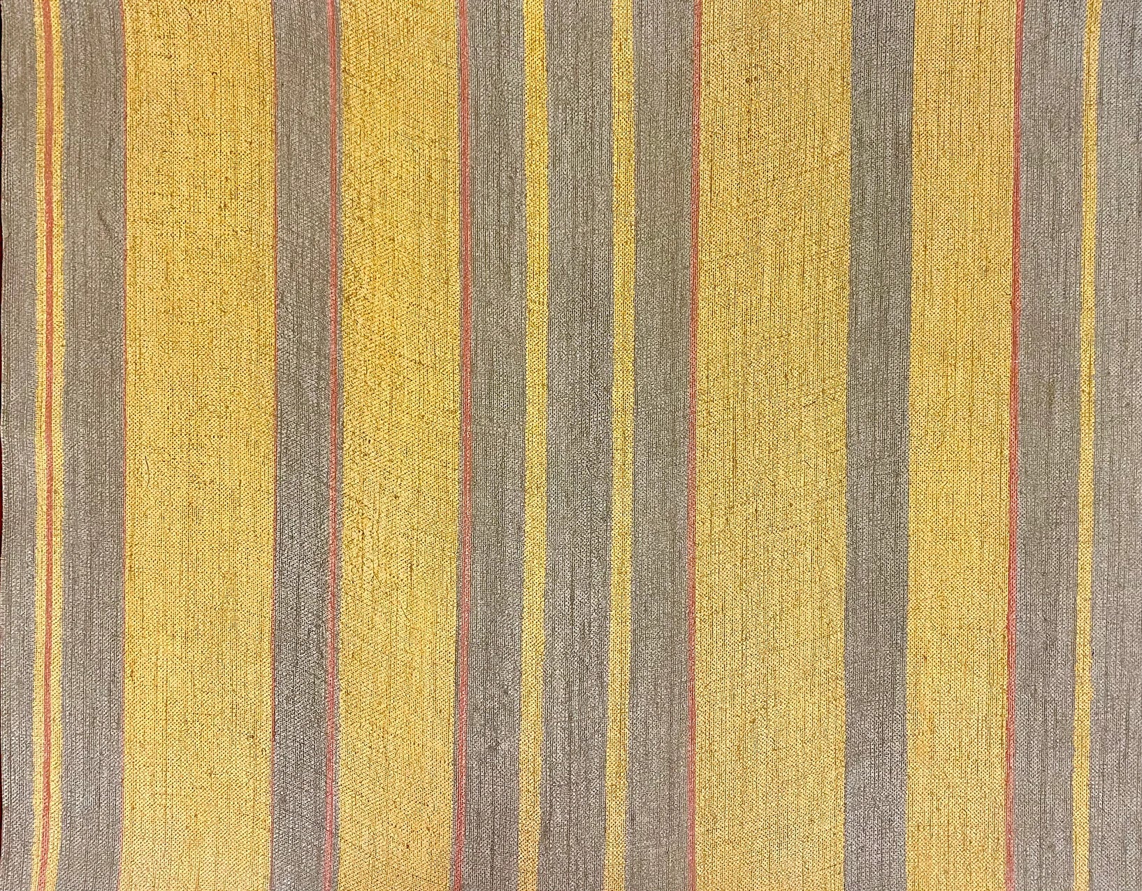 Detail of wallpaper in an irregular stripe print in shades of brown, yellow and coral.